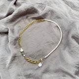 The Aletta Necklace by Third & Co. Studio: fresh water pearl, vintage gold-toned chain, mother of pearl and labradorite, create this adjustable length, wear-two-ways necklace. Can also be worn as a bracelet by wrapping around the wrist. Necklace shown against a silky gray fabric background