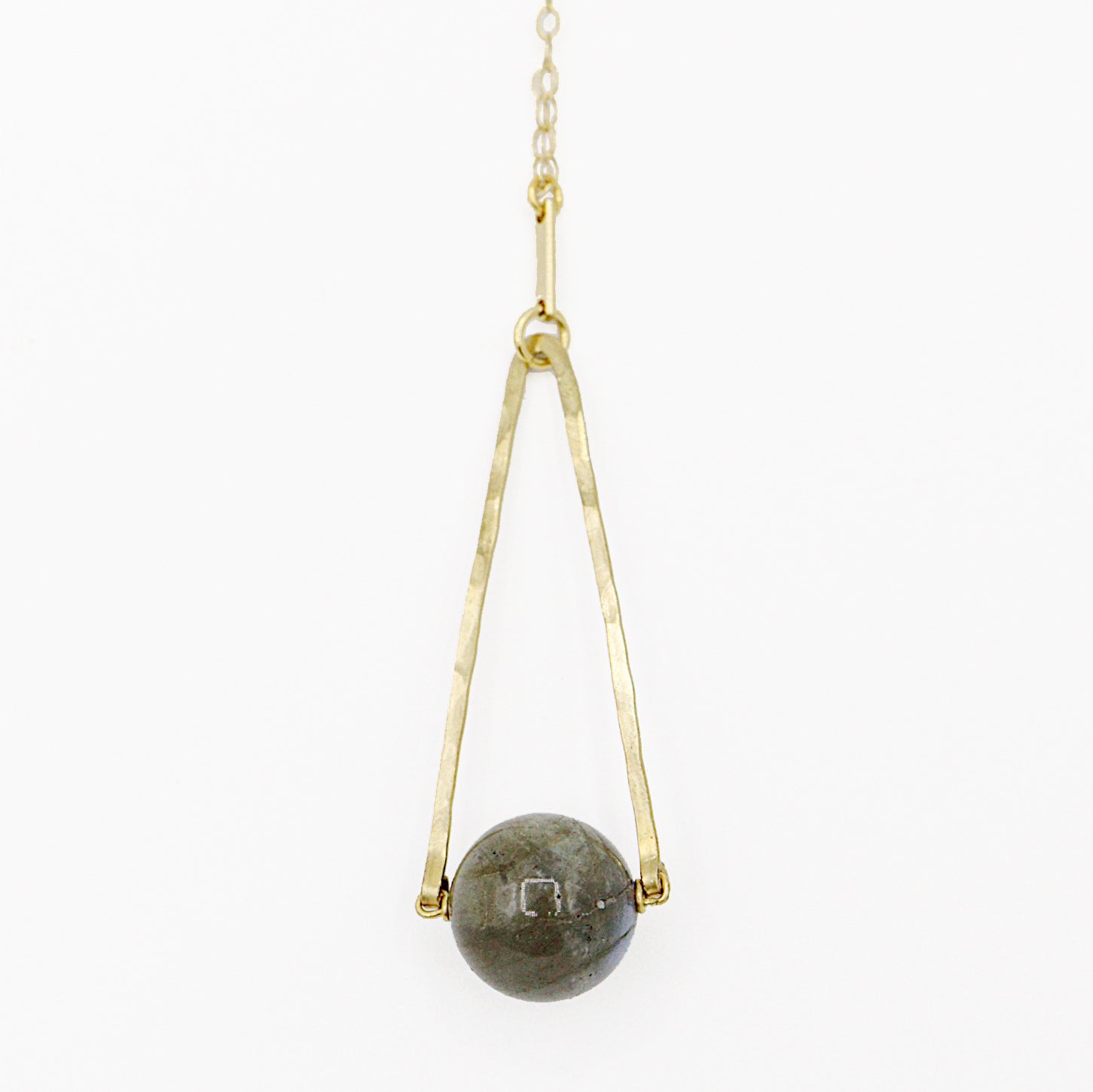 Round Labradorite in green, gray and flashes of blue with an elongated triangular hammered brass frame, a small vintage bar accent and 14K gold fill chain 30" length necklace