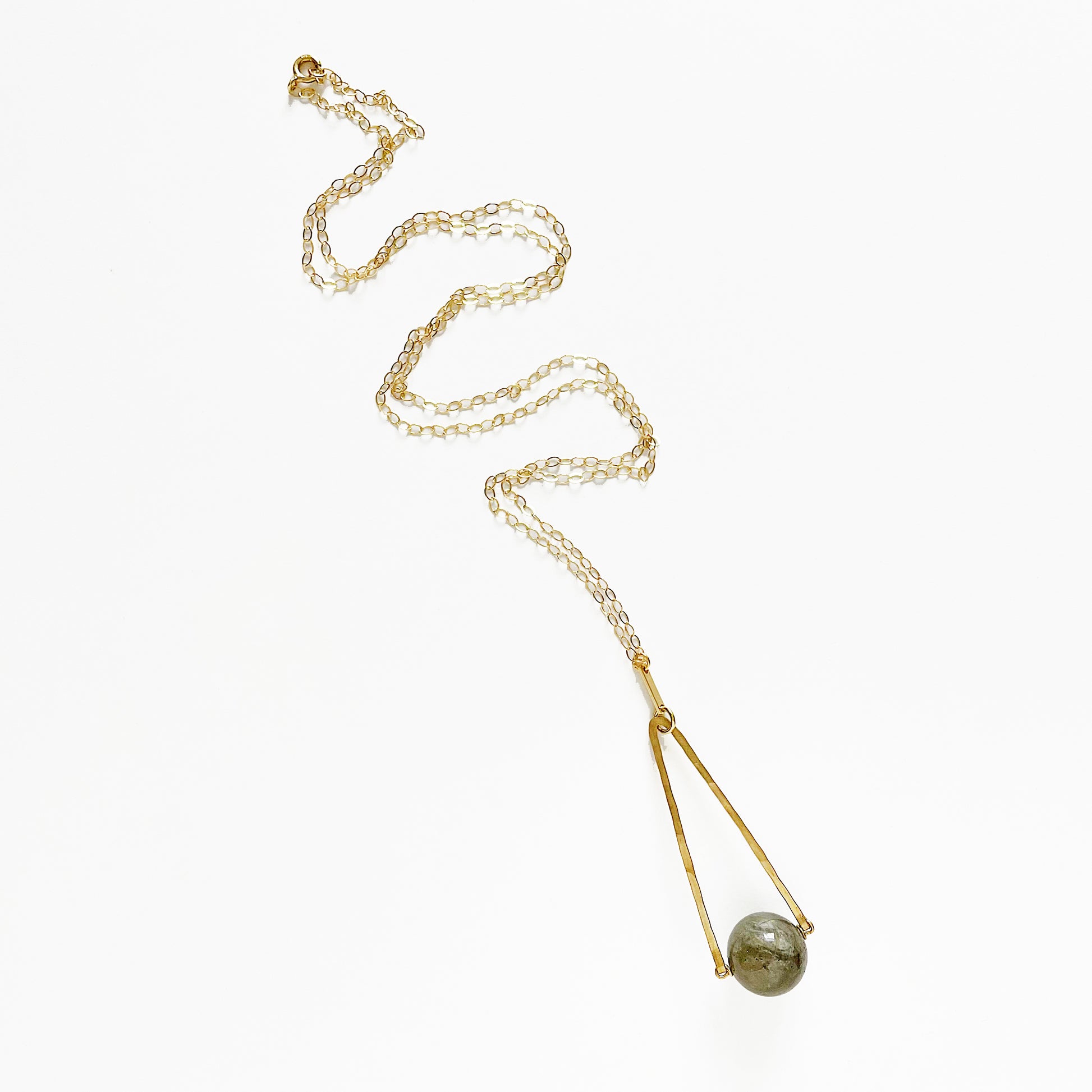 Round Labradorite in green, gray and flashes of blue with an elongated triangular hammered brass frame, a small vintage bar accent and 14K gold fill chain 30" length necklace