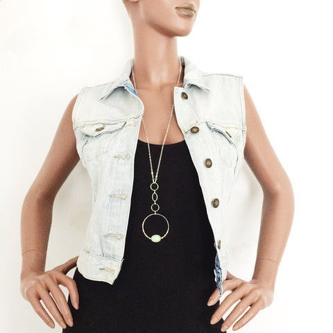 mannequin wearing the Apogee Necklace by Third & Co. Studio; light green and brown Chrysophase flat oval, vintage silver circle & oval chain, silver plated nickel-free chain, hammered German silver nickel circle, shown against a white backdrop
