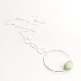 Apogee Necklace by Third & Co. Studio; light green and brown Chrysophase flat oval, vintage silver circle & oval chain, silver plated nickel-free chain, hammered German silver nickel circle, shown on a white background