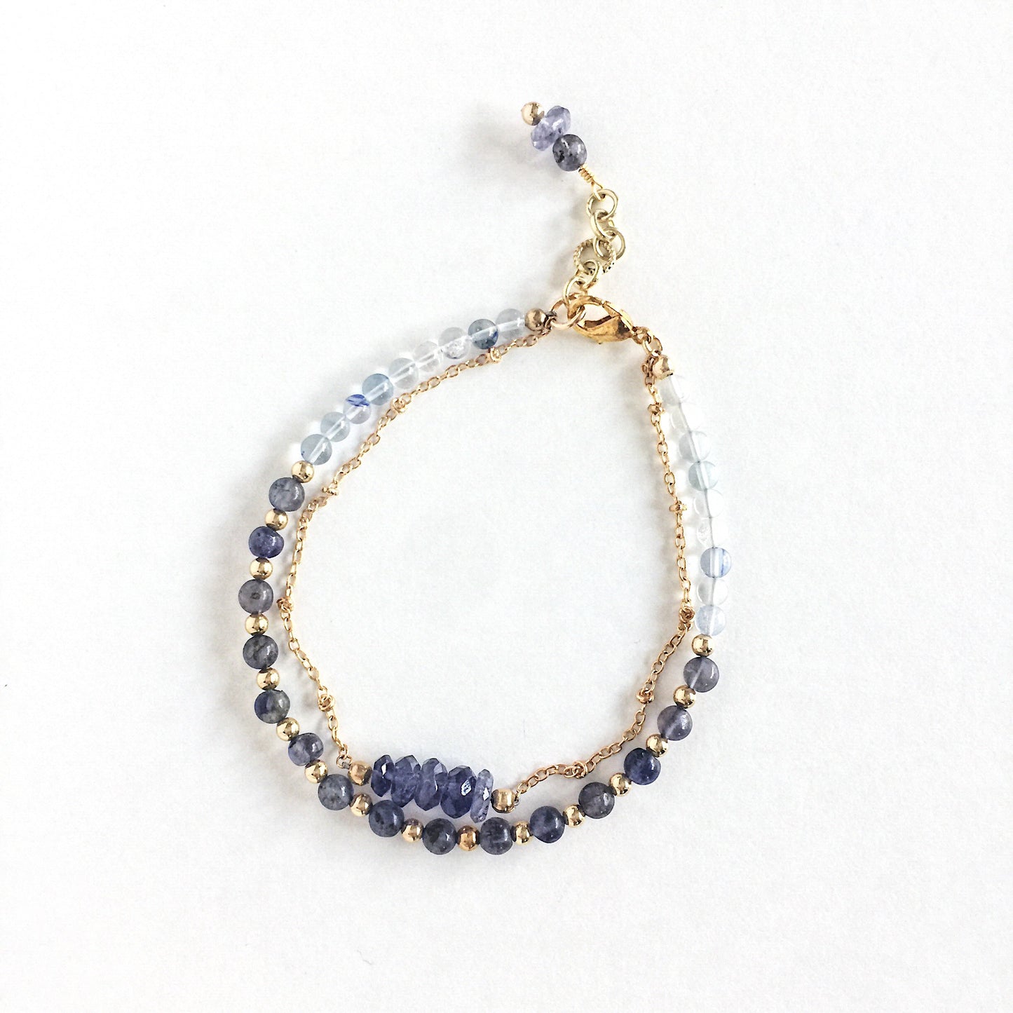 Andromeda Bracelet by Third & Co. Studio; faceted Iolite, round Quartz and Iolite, gold plated satellite chain adjustable length bracelet with lobster claw clasp, shown against a white background