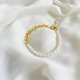 Aletta Bracelet from Third & Co. Studio with white fresh water pearl, gold plated vintage chain with adjustable length against a creamy silky fabric background