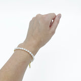a model wearing the Aletta Bracelet from Third & Co. Studio with white fresh water pearl, gold plated vintage chain with adjustable length on the wrist against a white background