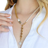 The Aletta Necklace by Third & Co. Studio: fresh water pearl, vintage gold-toned chain, mother of pearl and labradorite, create this adjustable length, wear-two-ways necklace. Can also be worn as a bracelet by wrapping around the wrist. Necklace shown on a model in a white top, at the shortest lariat length, against a white background